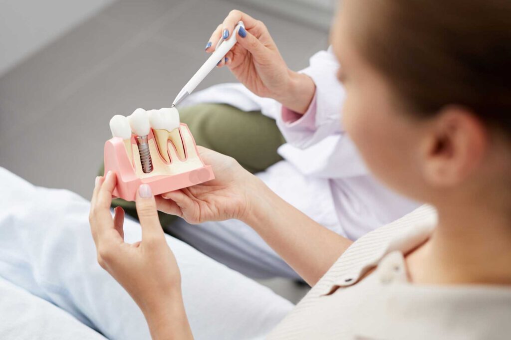 showing a patient a dental implant model