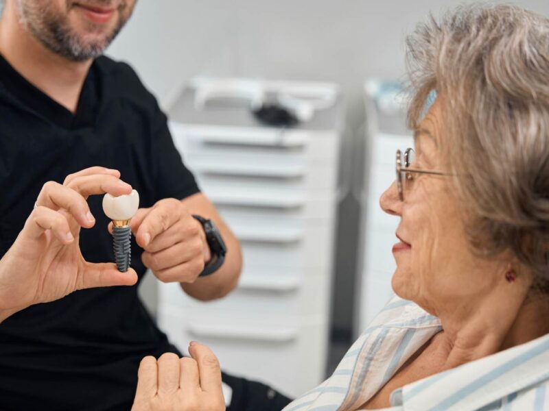 showing dental implant to patient